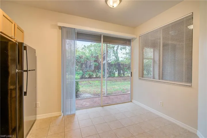 Empty room with light tile patterned floors