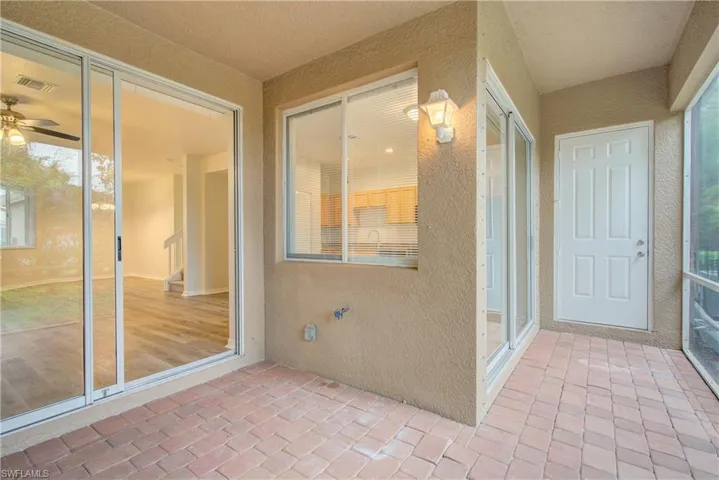 Unfurnished sunroom with ceiling fan