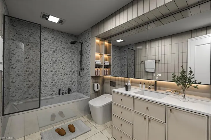 Full bath featuring tile walls, tiled shower / bath, vanity, and light tile patterned floors