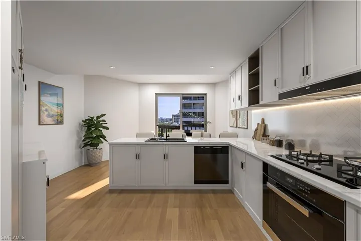 Kitchen featuring a peninsula, open shelves, black appliances, light stone counters, and light wood-style floors