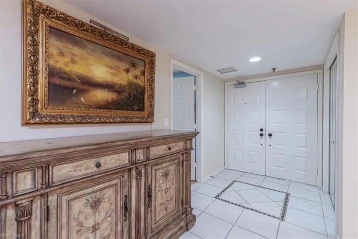 Foyer with light tile patterned floors, recessed lighting, and inlaid floor details