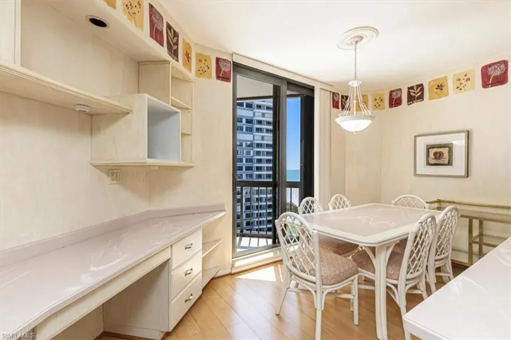 Dining room with expansive windows and light wood-style flooring