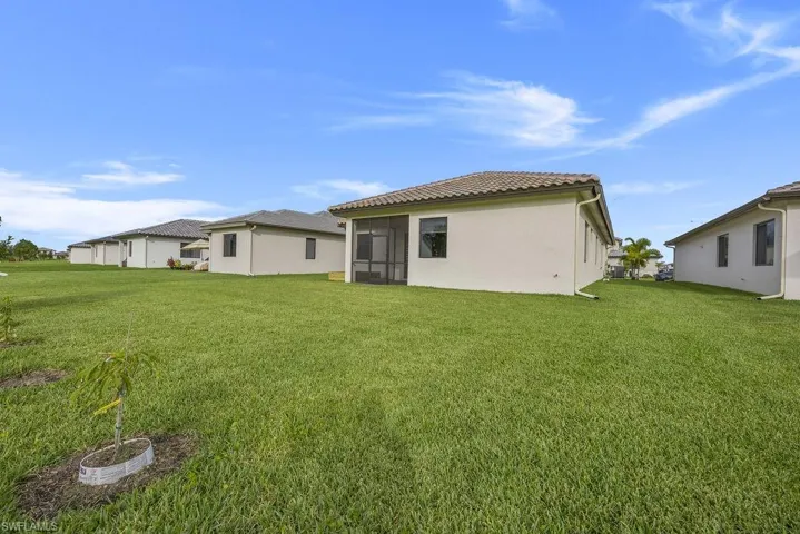 Rear view of house with a yard