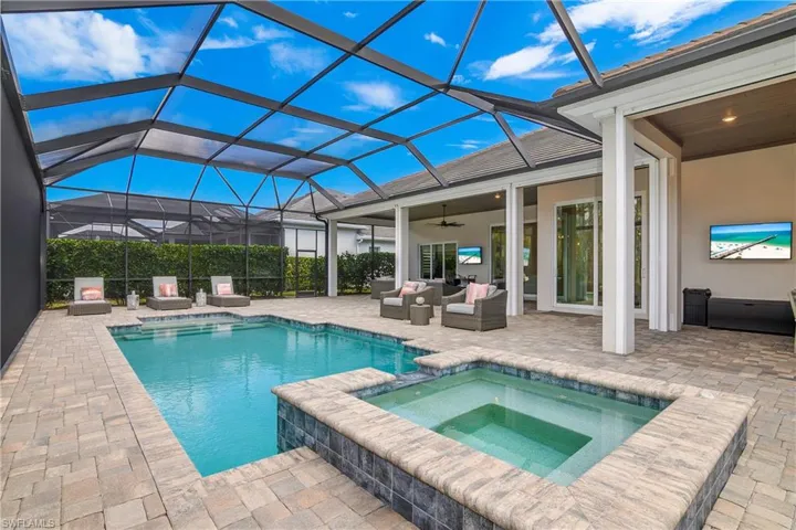 Integrated pool / spa with a patio area, a sunroom, a lanai, and outdoor lounge area