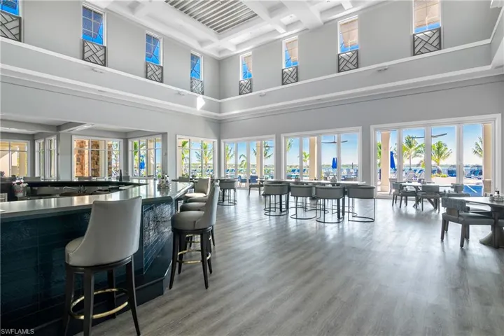 Bar area with coffered ceiling and dark countertops