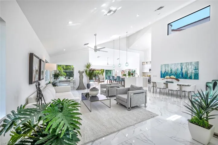 Living room with high vaulted ceiling and ceiling fan