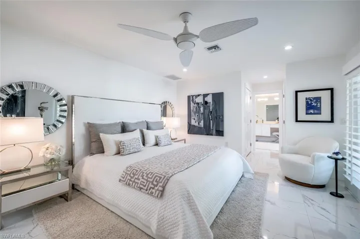 Bedroom with ceiling fan and ensuite bath