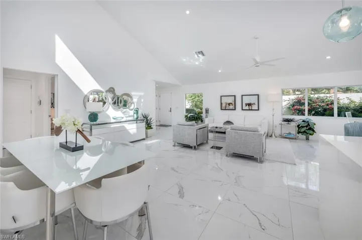 Dining room with high vaulted ceiling and ceiling fan