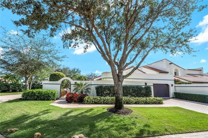 View of front of property with a front lawn and a garage