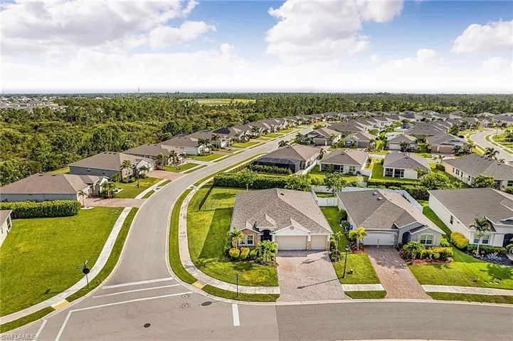 Aerial perspective showcasing a residential community with numerous single-story homes