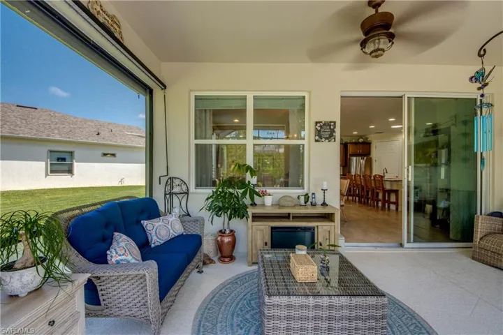 View of patio with outdoor lounge area and ceiling fan