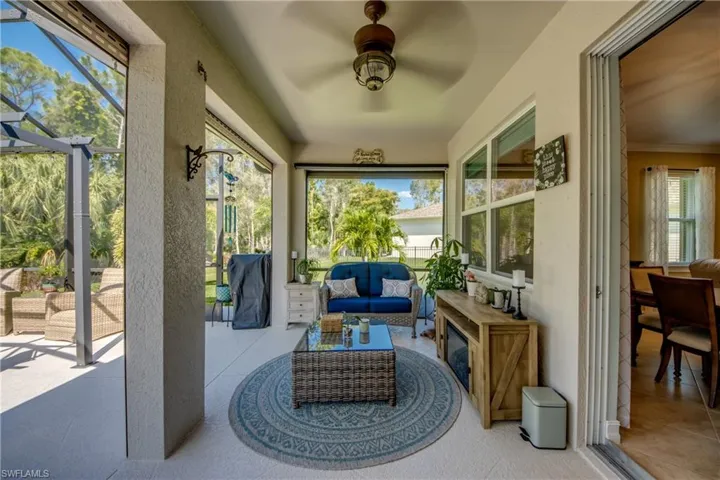 Sunroom / solarium with a wealth of natural light and ceiling fan