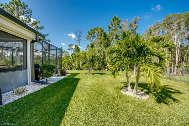 View of yard with glass enclosure