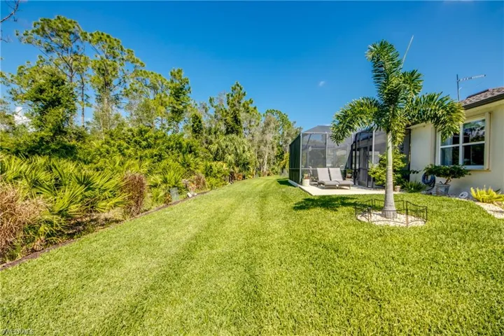 View of yard with a patio area and glass enclosure
