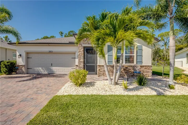 View of front of home featuring a front yard and a garage