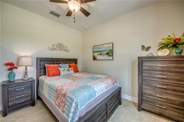 Carpeted bedroom with ceiling fan
