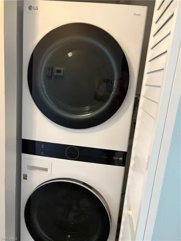 Laundry room featuring stacked washer / dryer