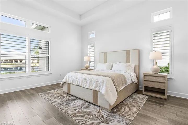 Bedroom featuring multiple windows and light wood finished floors