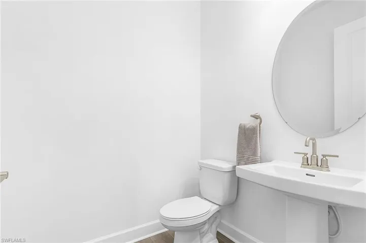 Bathroom with baseboards and wood finished floors