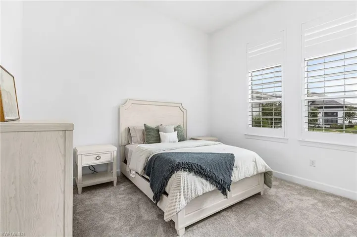 Carpeted bedroom with baseboards