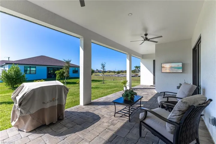 View of patio with a ceiling fan and grilling area