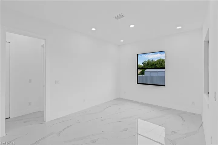 Empty room featuring recessed lighting and light marble finish floors
