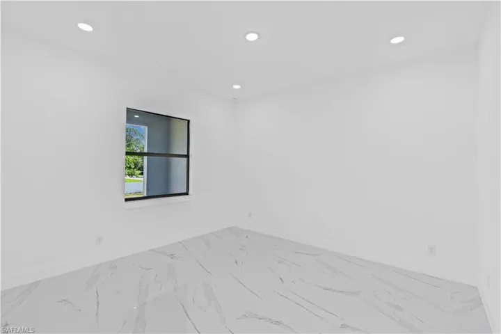 Empty room with recessed lighting and light marble finish floors