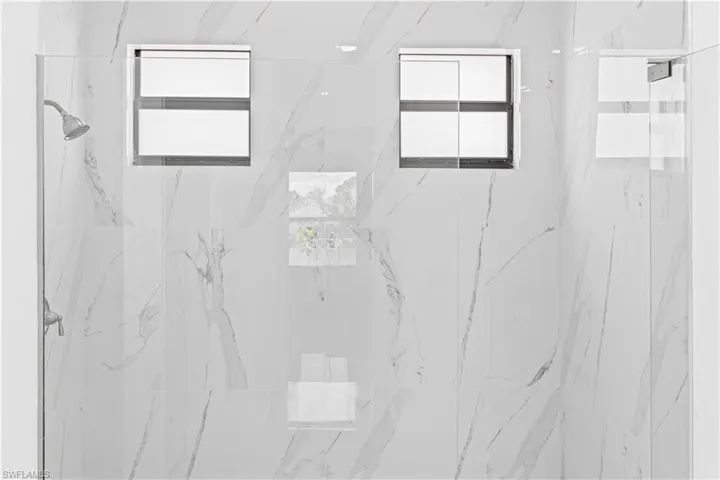Bathroom view of a marble finish shower