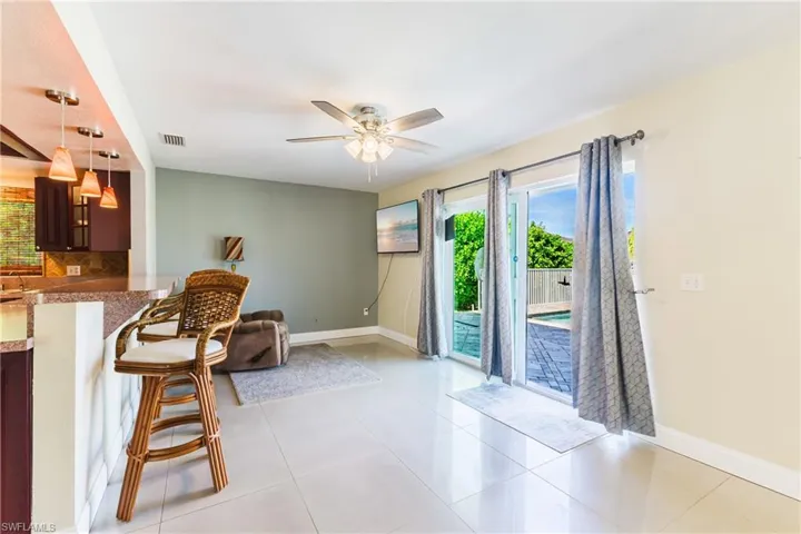 Sitting room with light tile patterned floors and ceiling fan