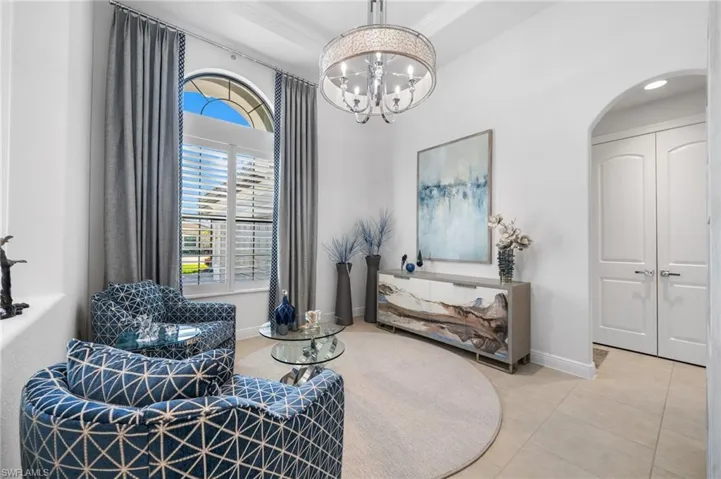 Lovely sitting area off of the entry with designer light fixture!