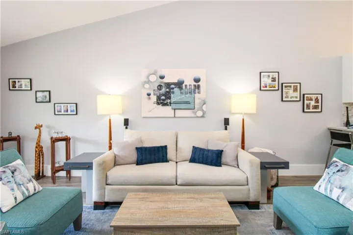 Living room featuring vaulted ceiling and hardwood / wood-style flooring
