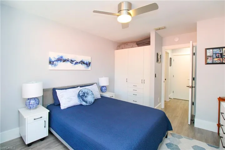 Bedroom with a closet, light wood-type flooring, and ceiling fan