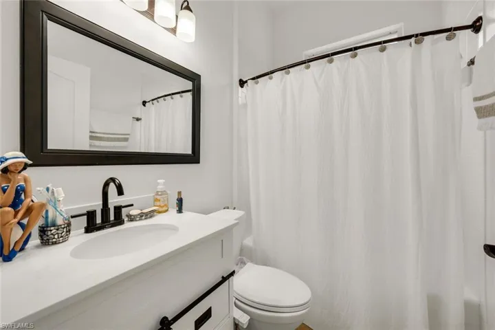 Bathroom with vanity and shower / bath combination with curtain