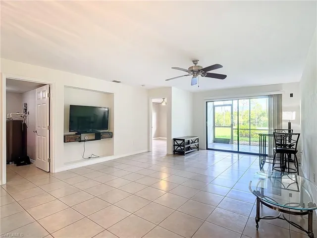 living room featuring ceiling fan and light tile patterned floors