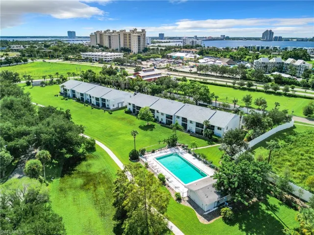 Birds eye view of property with a water view