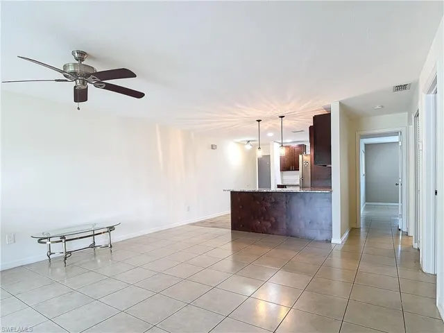 living room with light tile patterned flooring and ceiling fan
