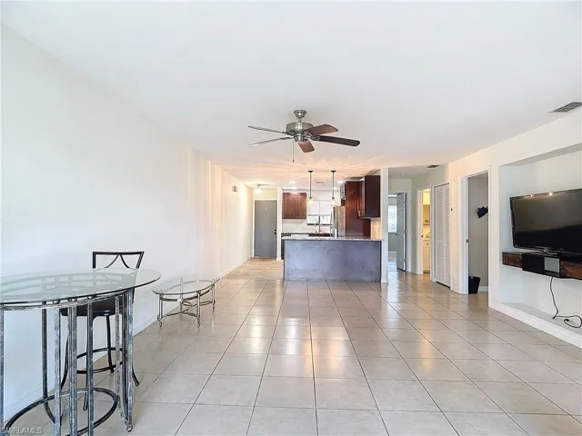 living room featuring ceiling fan and light tile patterned floors