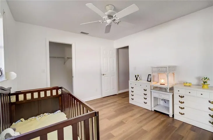Second Guest Bedroom also features a walk-in closet, ceiling fan, and the warm wood-like flooring.  This room is right off the pool for your guests who would like a moonlight swim.
