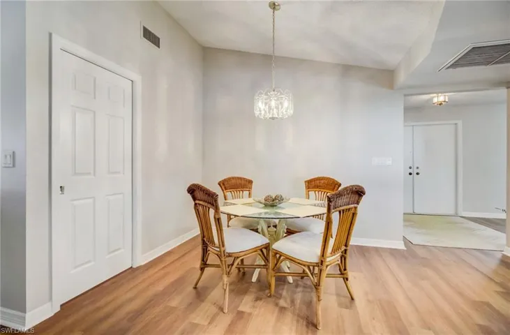 Breakfast nook with an inviting chandelier and light wood-look flooring