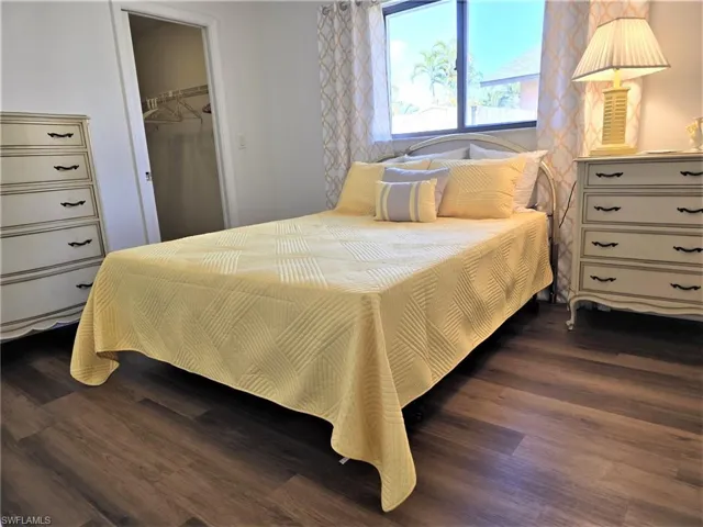 First Guest Bedroom features a spacious walk-in closet, lots of natural light and warm wood-style flooring