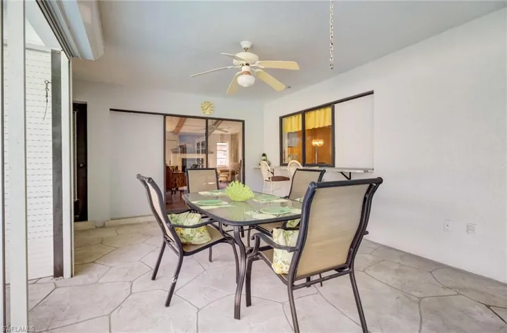 Pool deck has room for a large outdoor dining table and a passthrough window with bar