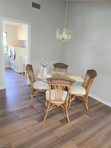 Breakfast nook showing the entrance to the laundry room with washing machine, clothes dryer and a utility sink.