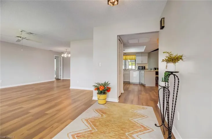 As you enter the foyer, the living room is to the left and the kitchen is directly in front of you.