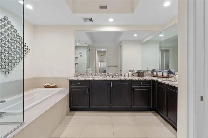 Primary Bathroom featuring vanity, light tile patterned flooring, a garden tub, a tile shower, and recessed lighting