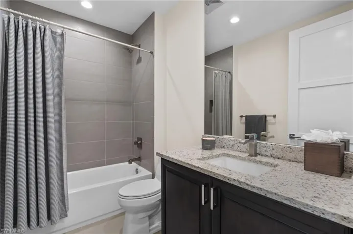 Guest Bathroom featuring shower / tub combo, vanity, and recessed lighting