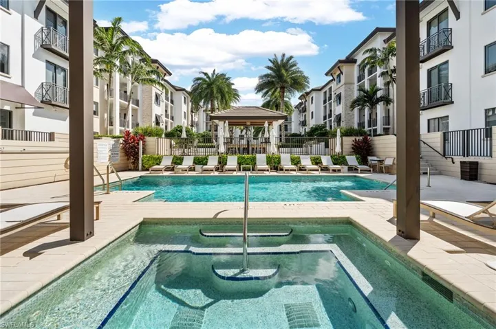 Community pool featuring a patio, a hot tub, and a gazebo