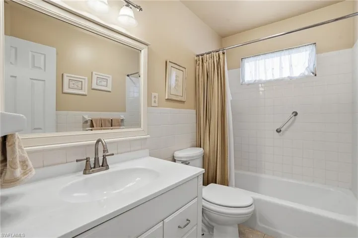 Bathroom featuring vanity, shower / bath combo,  - Virtually Edited Image