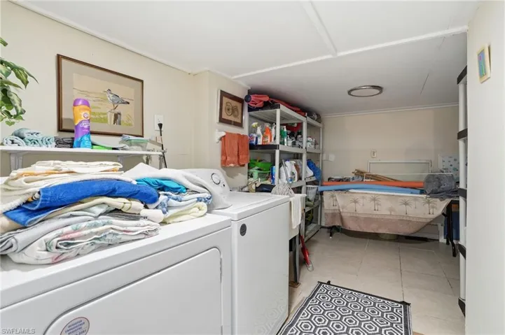 Laundry area featuring washer and dryer and bathroom - Virtually Edited Image