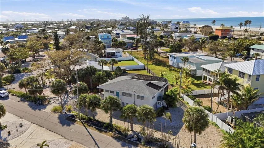 Aerial perspective of home with Gulf beach just a few minute walk away - Virtually Edited Image