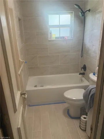 Bathroom featuring  shower combination and toilet